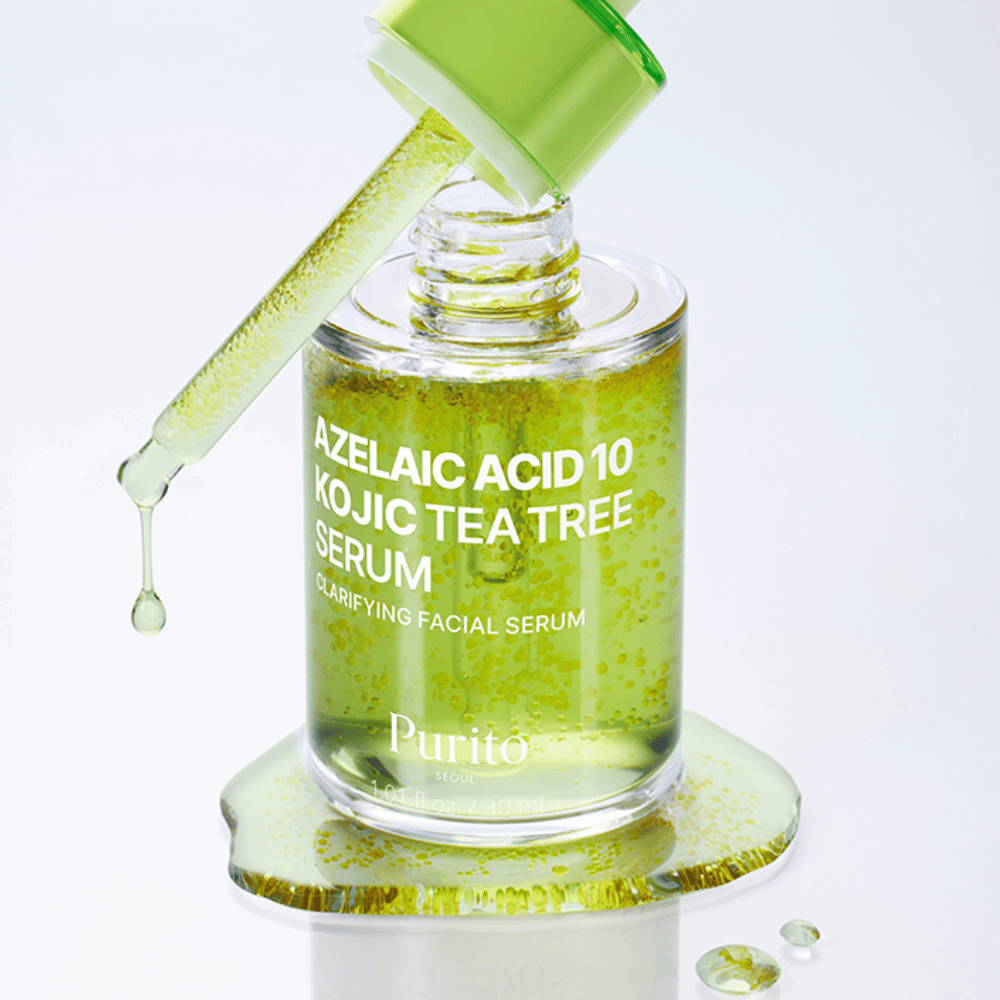 Close-up de Purito Azelaic Acid 10 Kojic Tea Tree Serum com conta-gotas e gotas. Proporciona uma pele mais clara e reduz impurezas.