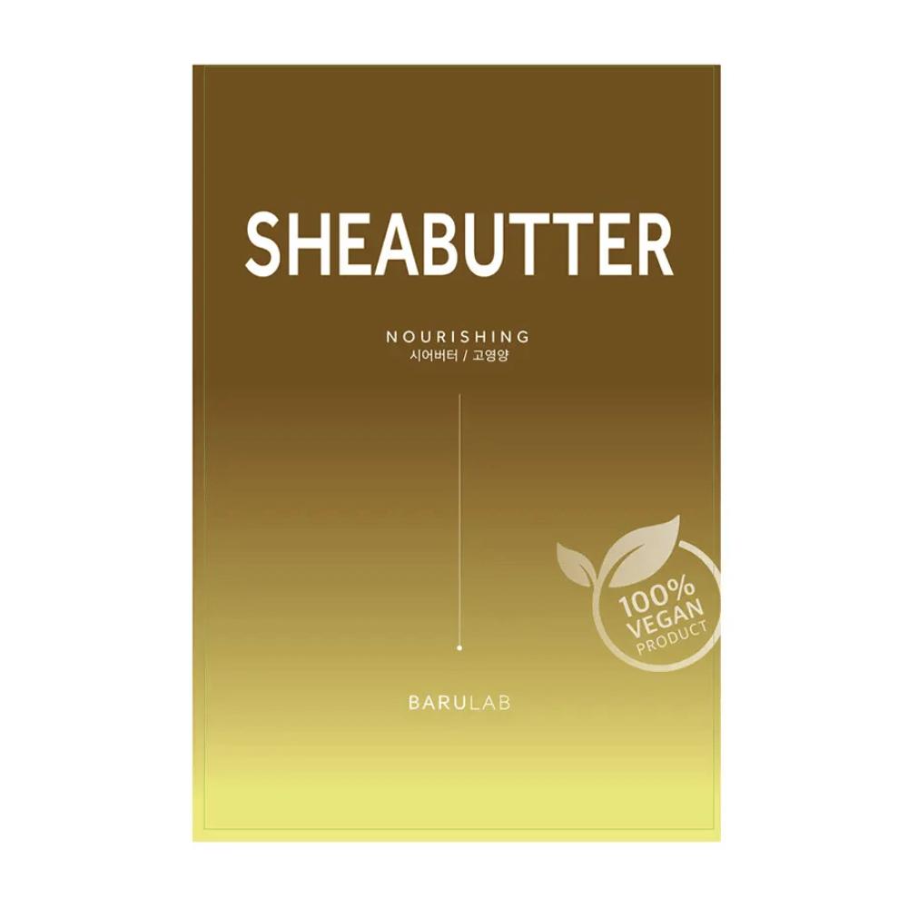 Uma embalagem de máscara "SHEABUTTER Nourishing" BARULAB, marcada como "100% Vegan Product". A embalagem tem um gradiente de cor que vai de um dourado escuro no topo para um amarelo claro na parte inferior.