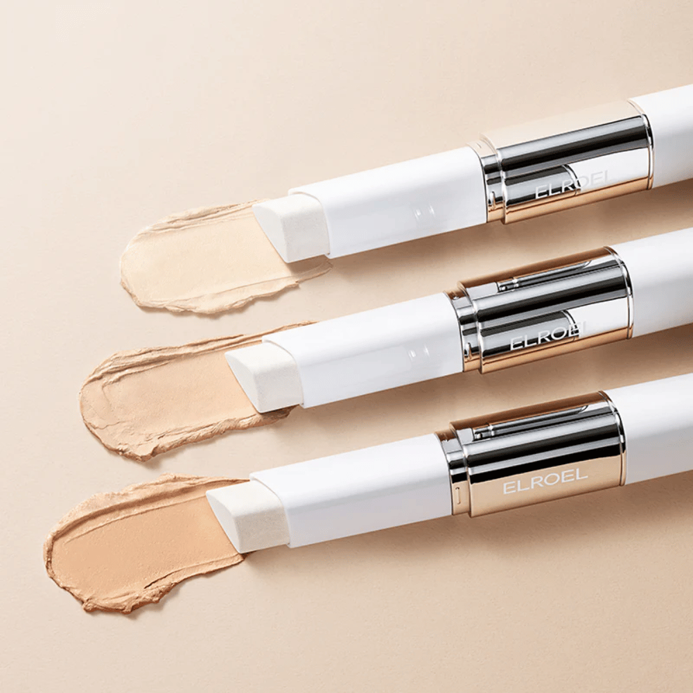 ELROEL Blanc Cover Cream Stick concealer com pincel integrado, vários sticks alinhados mostrando o design do produto e aplicação.