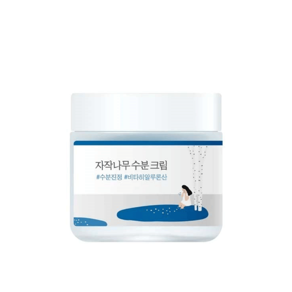 Round Lab Birch Juice Moisturizing Cream em frasco transparente com tampa branca e rótulo azul com ilustração de bétula e menina, destacado contra fundo branco.