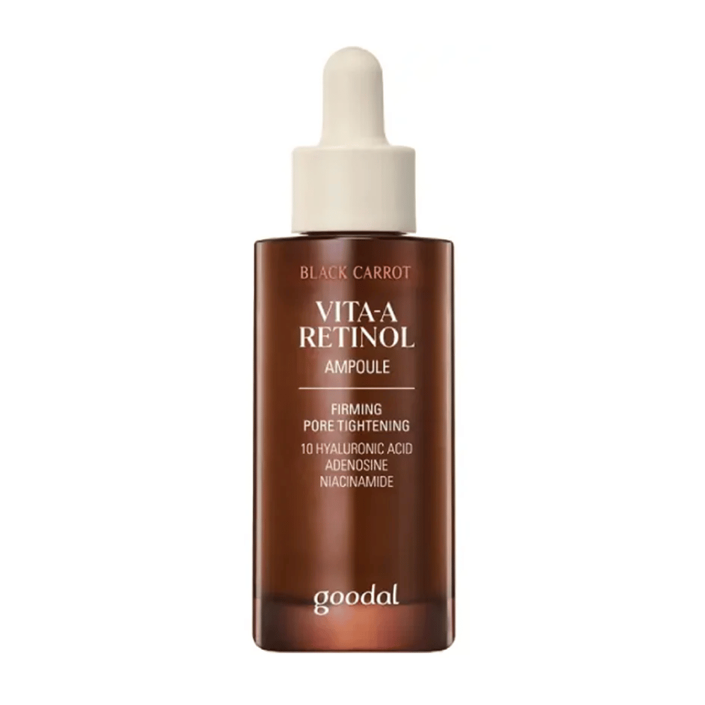 A garrafa com Goodal Black Carrot Vita-A Retinol Firming Ampoule é mostrada. Ela tem um conta-gotas bege e uma garrafa marrom escura. O rótulo descreve o produto como "Vita-A Retinol Ampoule" e menciona características como "Firming Pore Tightening", bem como os ingredientes 10% de ácido hialurônico, adenosina e niacinamida.