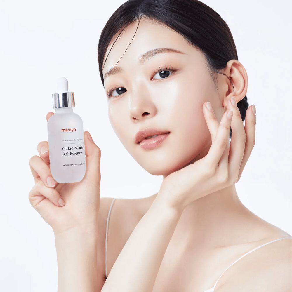 Mulher com pele radiante segura Ma:nyo Galac Niacin 3.0 Essence – essência coreana que proporciona um tom de pele mais uniforme e brilho natural.