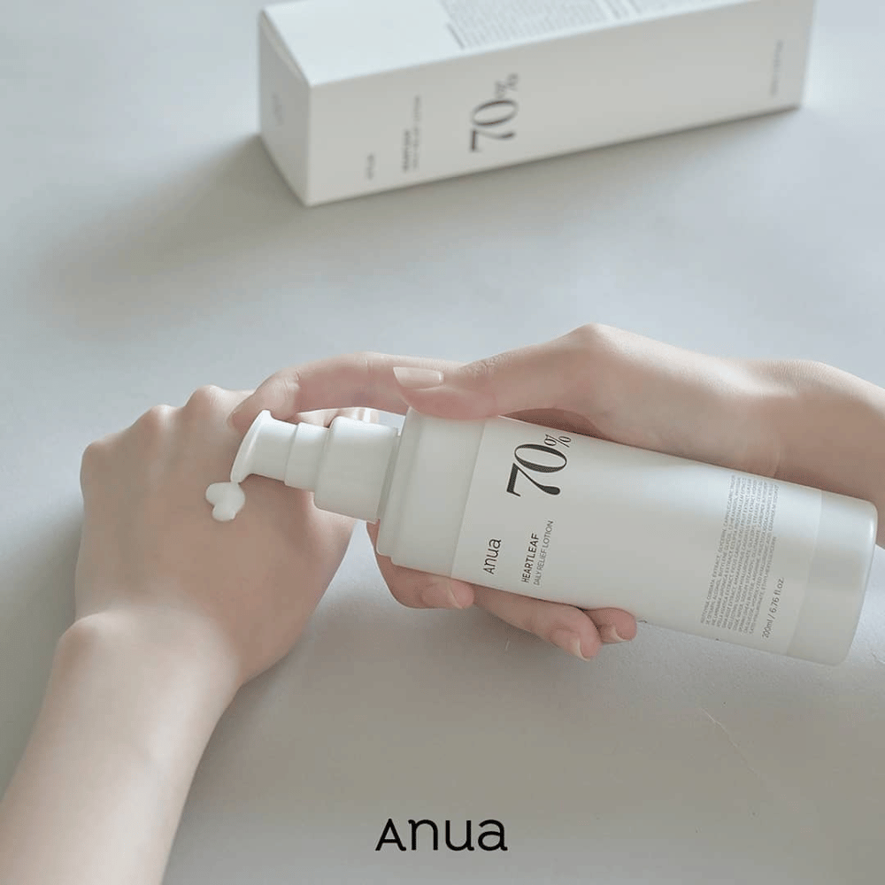 Uma pessoa segura uma garrafa Anua Heartleaf 70% Daily Lotion 200ml.