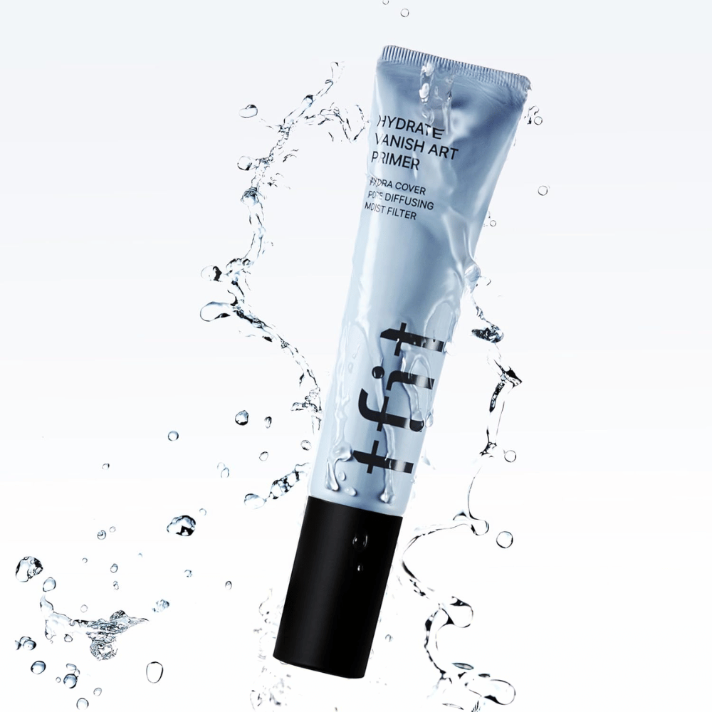TFIT Hydrate Vanish Art Primer em tubo azul é rodeado por respingos de água, simbolizando as propriedades hidratantes do produto e a sensação refrescante ao aplicar.