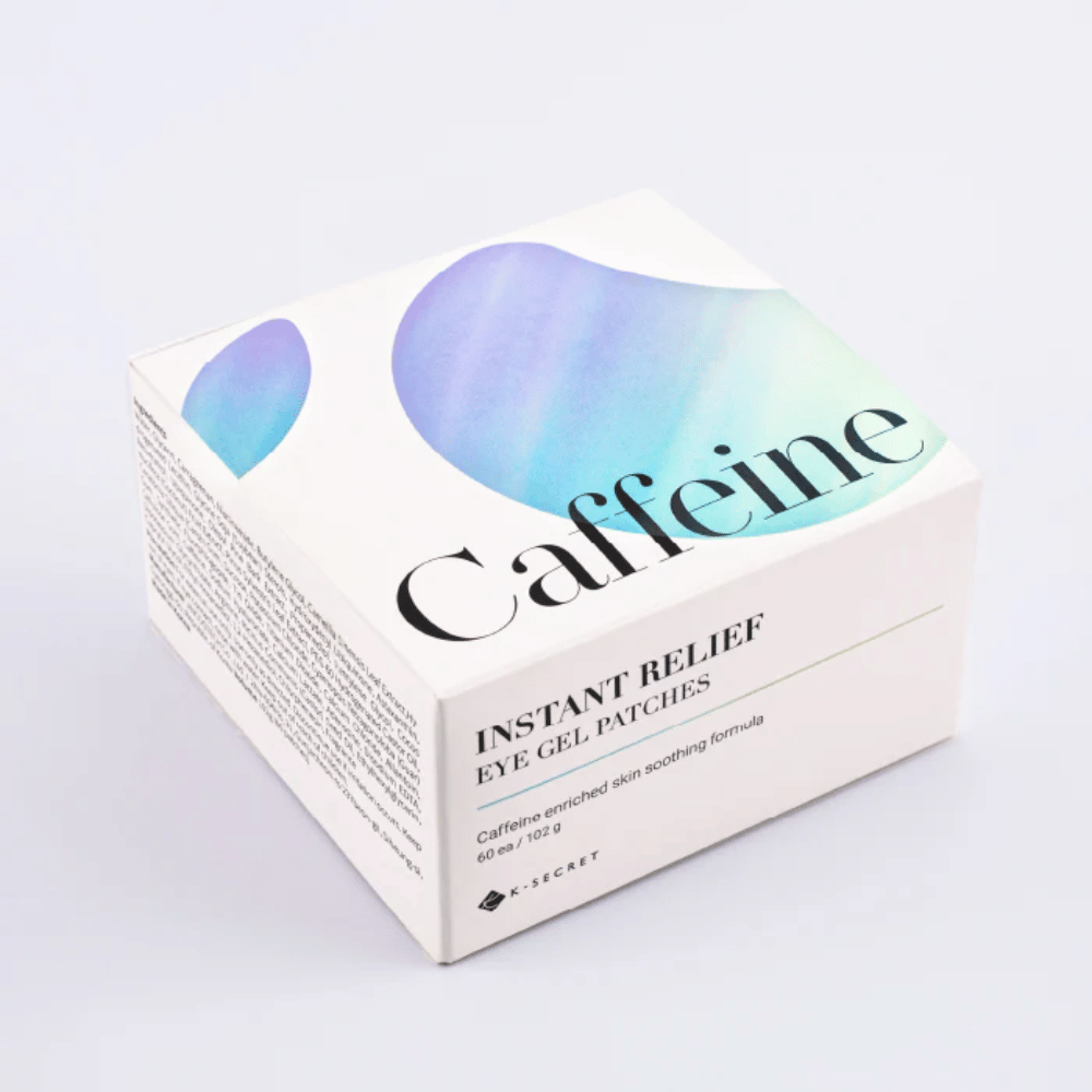 Embalagem de K-Secret Instant Relief Eye Gel Patches com cafeína em design branco com tons azuis e verdes.