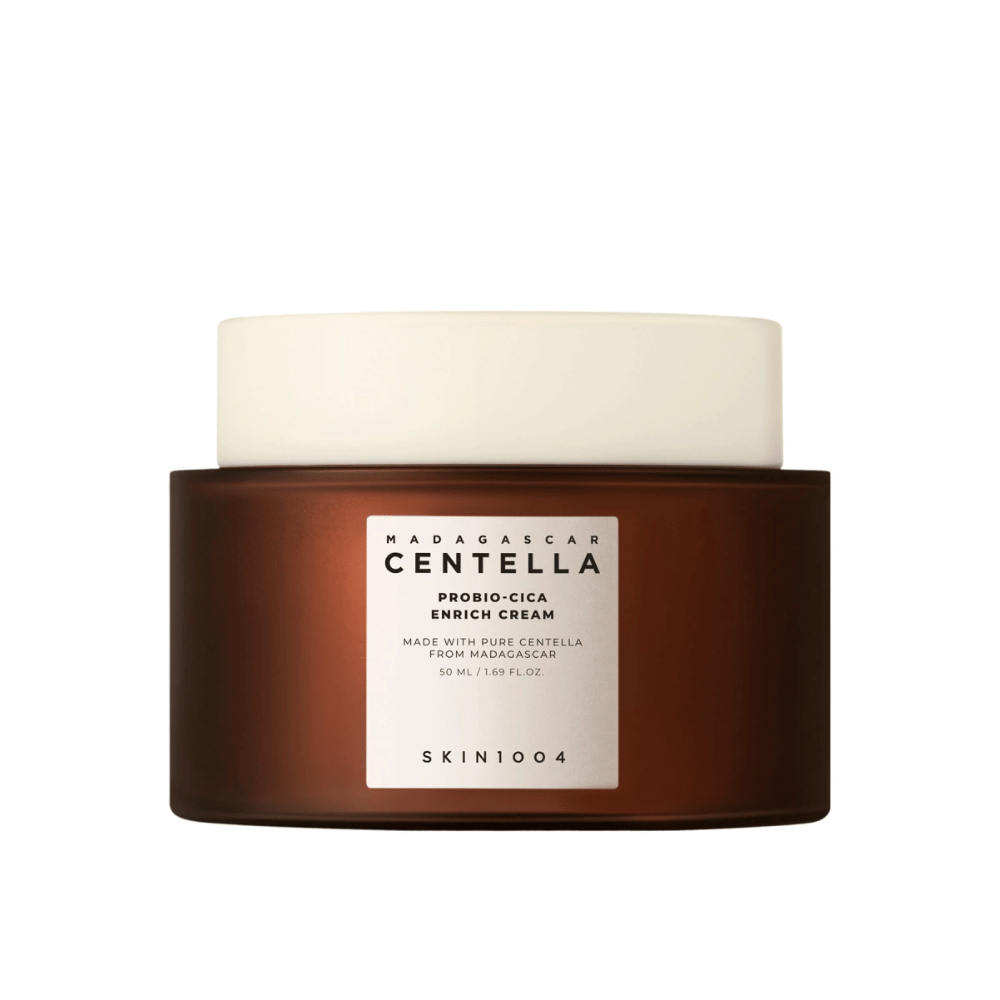 Um frasco marrom com Madagascar Centella Probio-Cica Enrich Cream contra um fundo neutro.