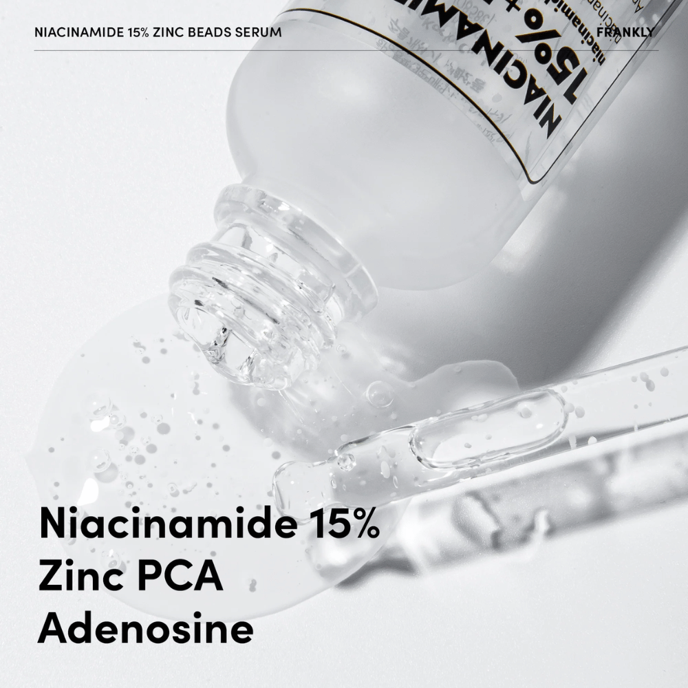 Close-up do FRANKLY Niacinamide 15% + Zinc Beads Serum sendo derramado. Texto mostra ingredientes: Niacinamida 15%, Zinc PCA e Adenosina.
