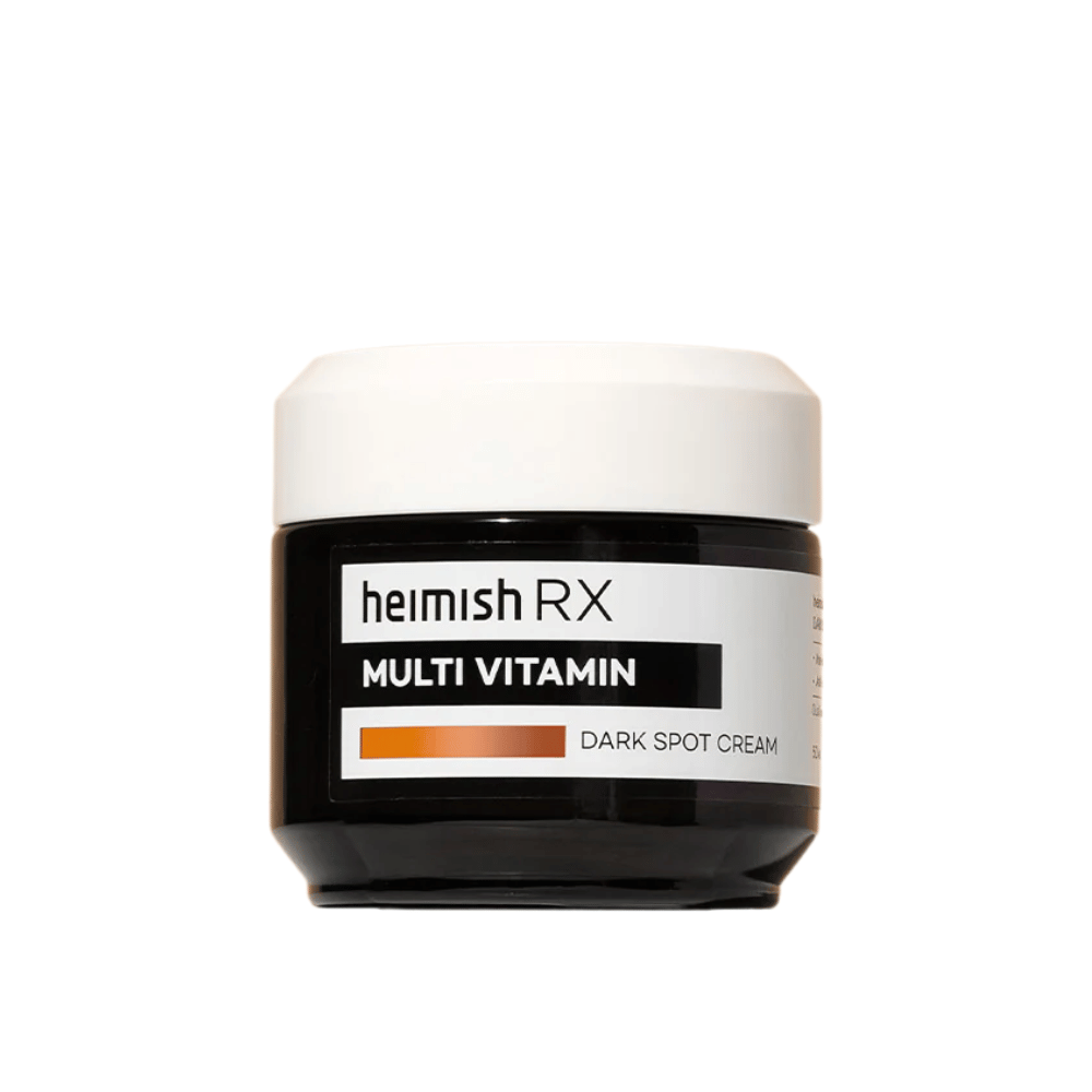 Heimish RX Multi Vitamin Dark Spot Cream em um frasco preto elegante com tampa branca. Um creme facial enriquecido com multivitaminas, desenvolvido para reduzir manchas escuras e uniformizar o tom da pele.