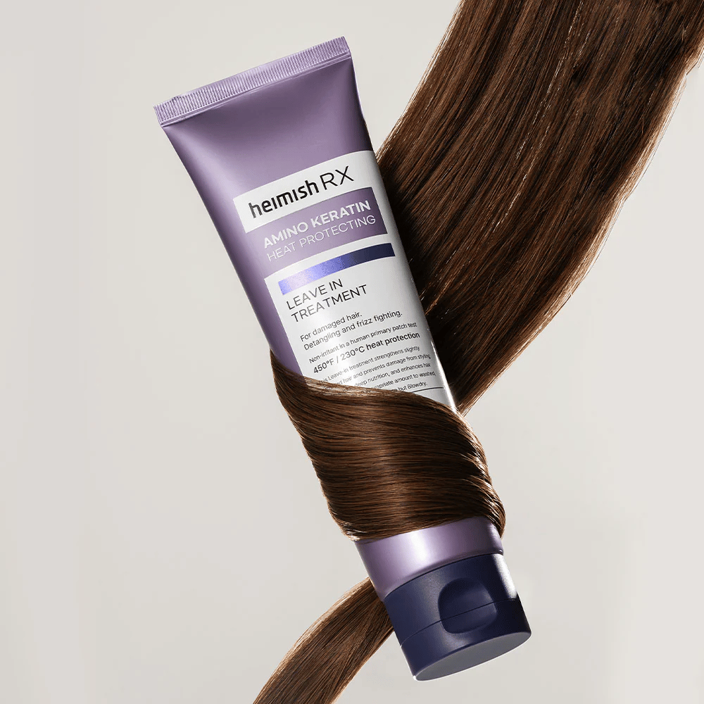Heimish RX Amino Keratin Leave-In Treatment – tratamento capilar nutritivo e protetor térmico cercado por cabelo brilhante, simboliza efeito fortalecedor e hidratante para cabelo danificado.