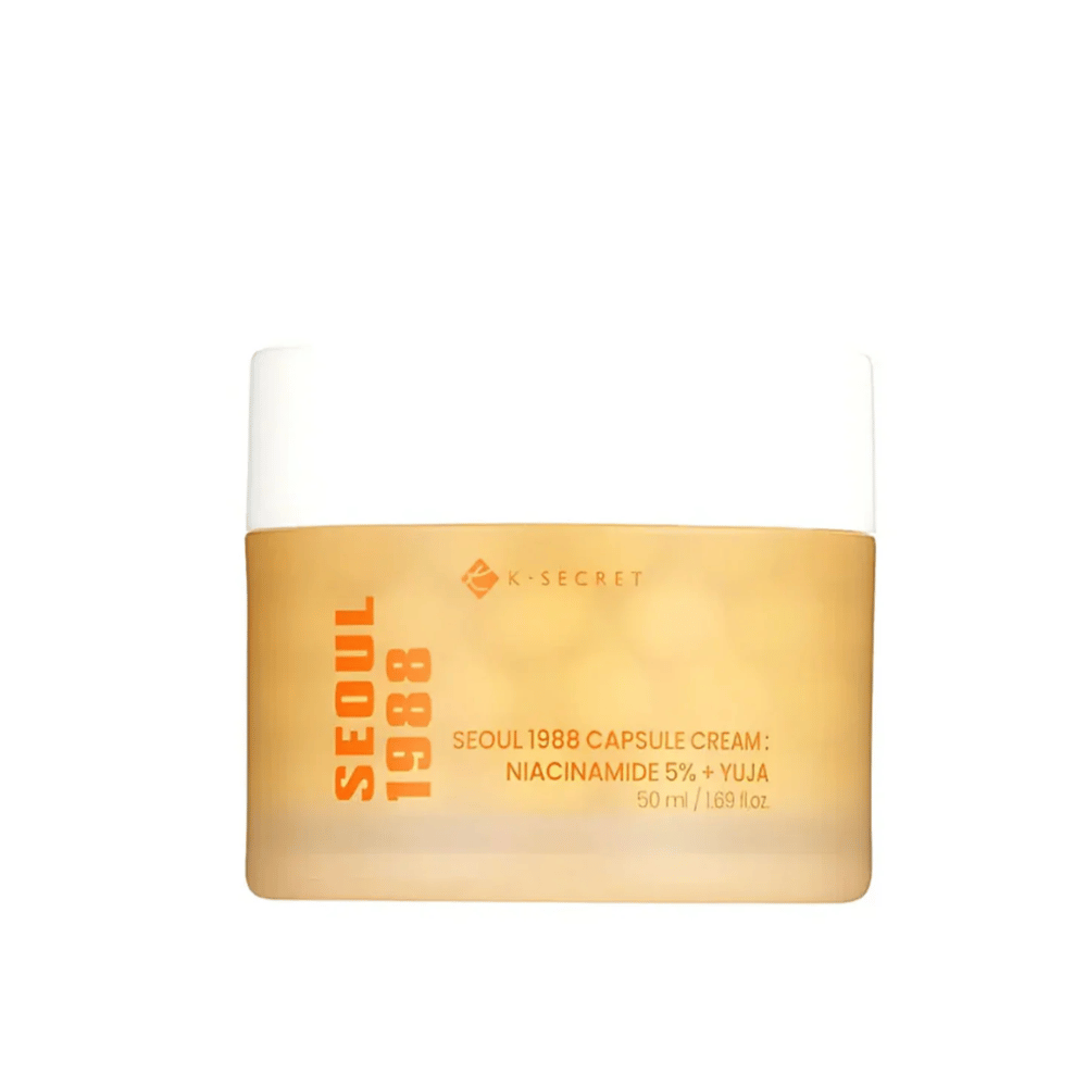Frasco com K-Secret Seoul 1988 Capsule Cream Niacinamida 5% + Yuja, 50 ml, em embalagem dourada e designada.