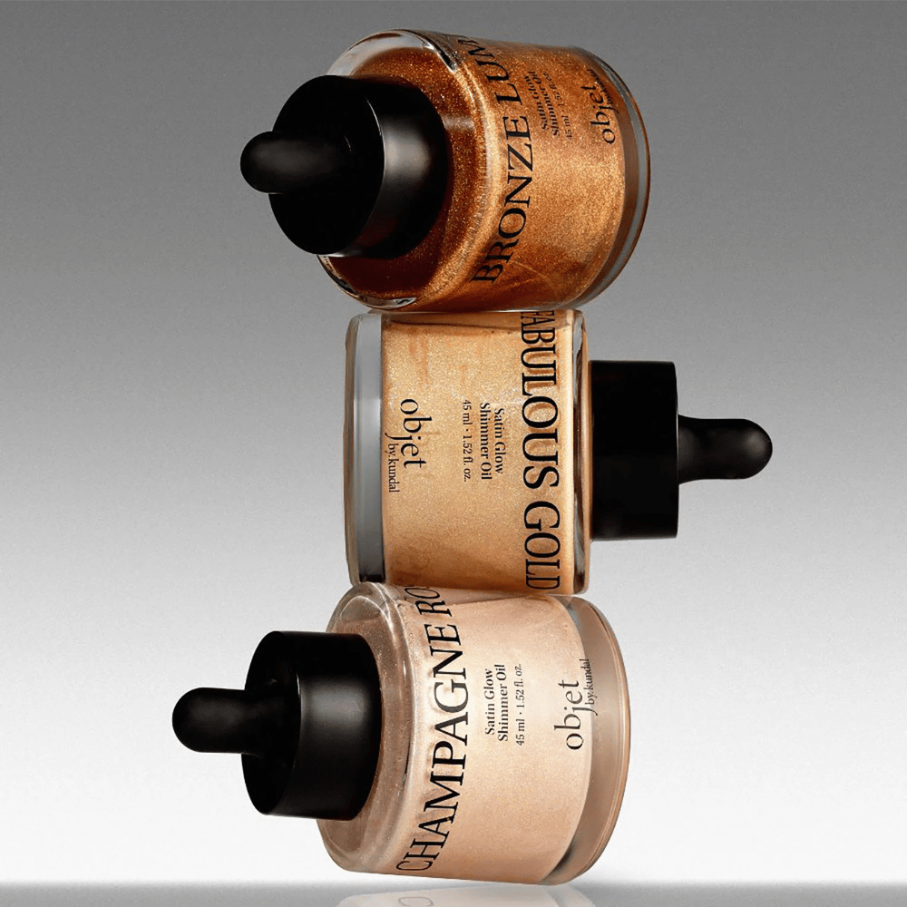 Objet by KUNDAL Satin Glow Shimmer Oil em Bronze Lumière, Fabulous Gold e Champagne Rose – óleos corporais cintilantes com acabamento iluminador.